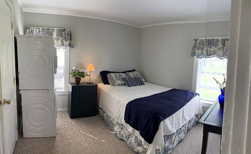 Bedroom with room darkening shades, Front load washer and dryer. Ensuite bathroom entrance just before washer and dyer on left side