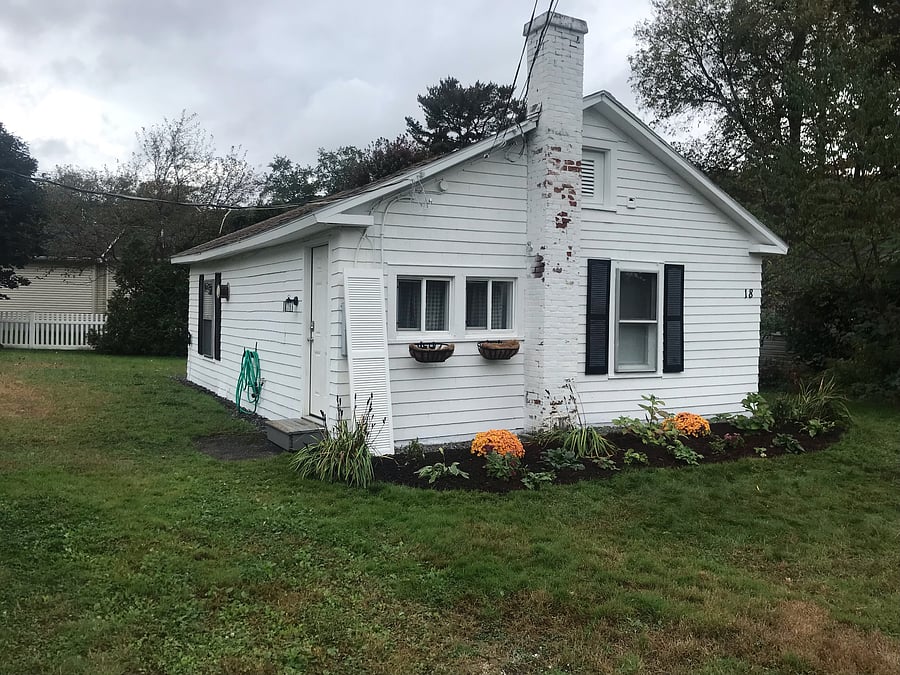 Cottage entrance from driveway with motion sensor lighting