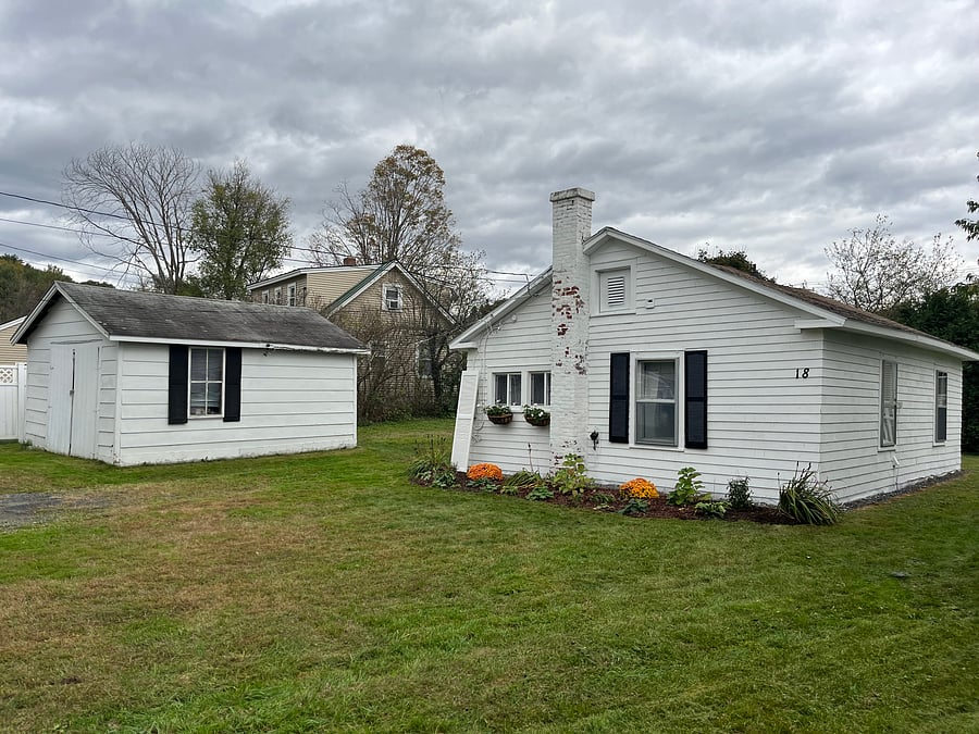 Cottage and garage with motion sensor lighting