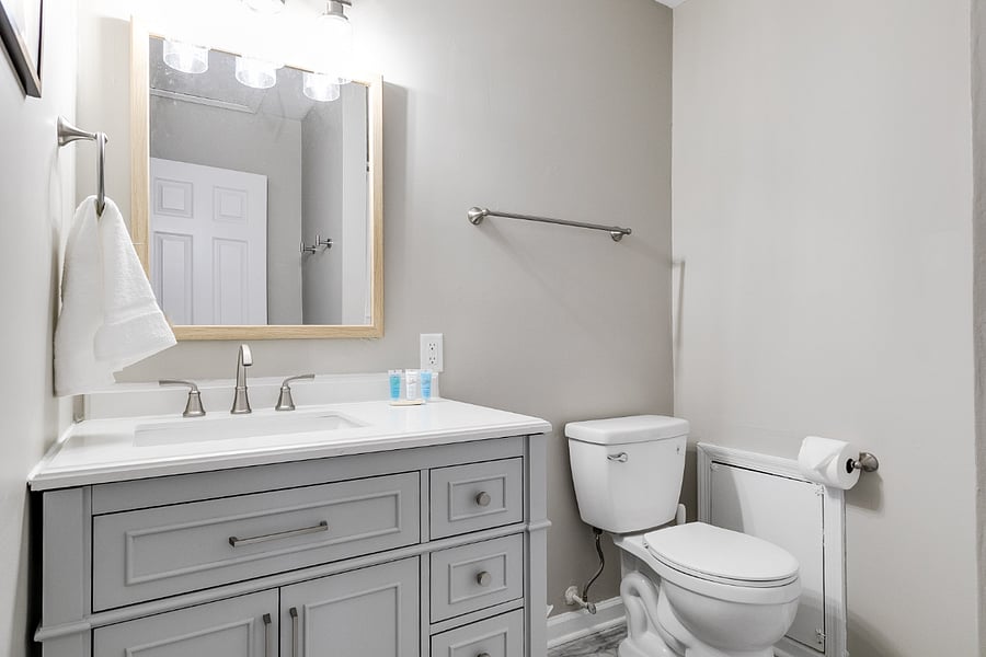 Large upstairs hallway full bath features vinyl tile floor, brand new oversized vanity and shower.