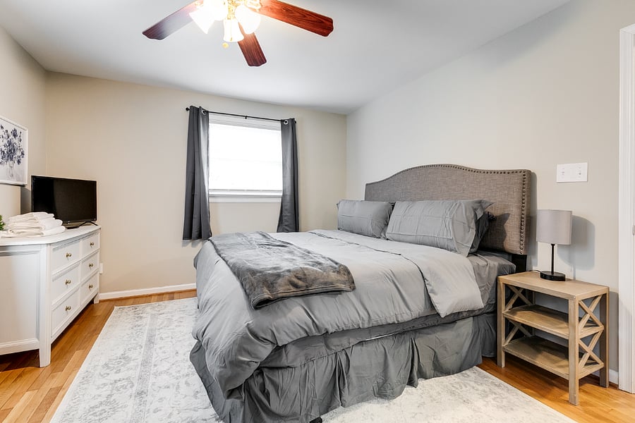 Large upstairs primary bedroom with king size cloud pillow top mattress, 30" HD TV, blackout curtains, ceiling fan, dresser, 2xnight stands, dedicated workspace and private bath with tub/shower combo.