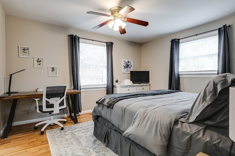 Large upstairs primary bedroom with king size cloud pillow top mattress, 30" HD TV, blackout curtains, ceiling fan, dresser, 2xnight stands, dedicated workspace and private bath with tub/shower combo.