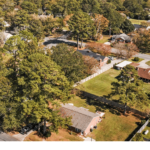 Arial view of shared yard and neighborhood. Side B is driveway on the right.  Side A is on the left under the tree