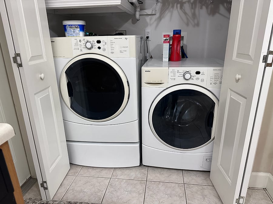 Large capacity front loading washer and dryer set off kitchen