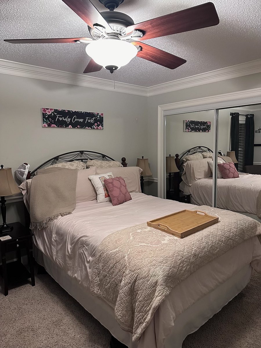 Second Bedroom with full mirror sliding doors to access closet and carpeting in bedrooms
