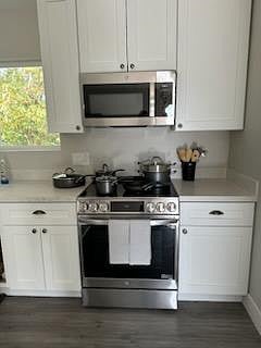 Kitchen has microwave, air fryer, full-size refrigerator/freezer and convection oven with five burner stove.