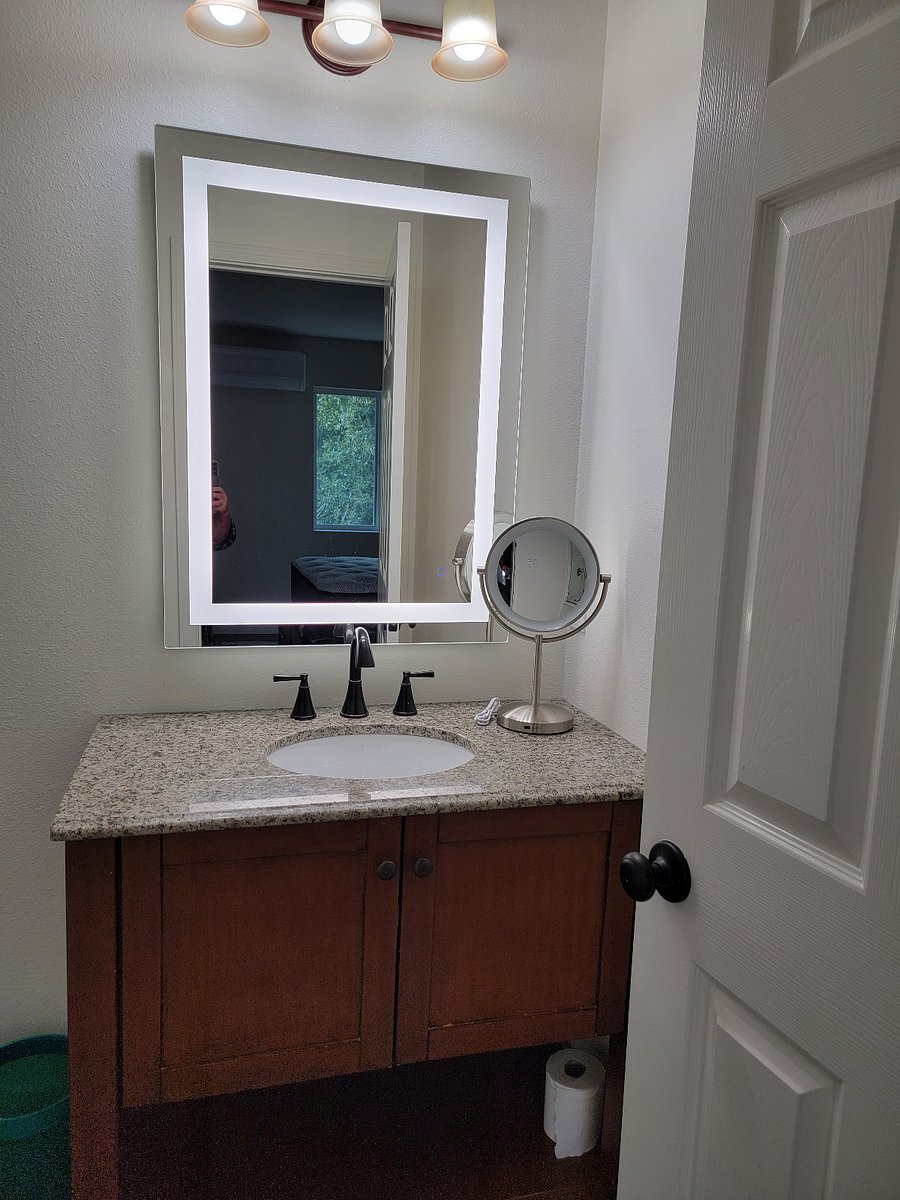 Tap the lighted mirror for different levels of illumination.