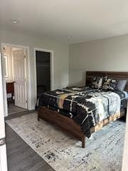King size bed, tall dresser and two nightstands with drawers.