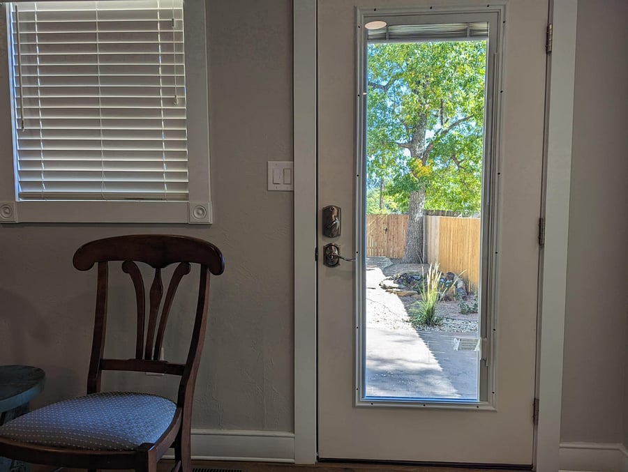 Looking out back door into fenced backyard