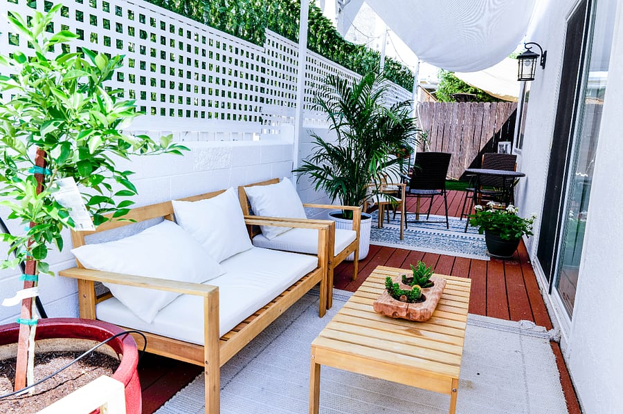 The private, outdoor patio is a lush and tranquil oasis filled with greenery. It offers a various seating options, creating a serene space for relaxation