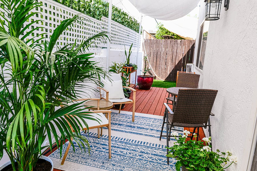 The private, outdoor patio is a lush and tranquil oasis filled with greenery. It offers a various seating options, creating a serene space for relaxation