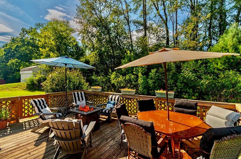 Enjoy relaxing around a fire in the evening on the large back porch. Open the umbrellas and read your favorite book in the shade. The porch leads to an enclosed fenced lot so your pups can play by your side.