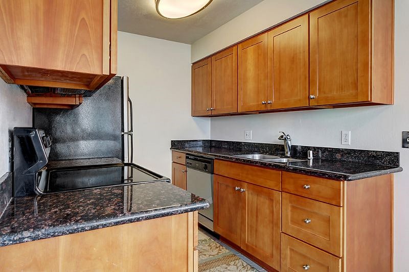 All granite surfaces and cherry cabinetry