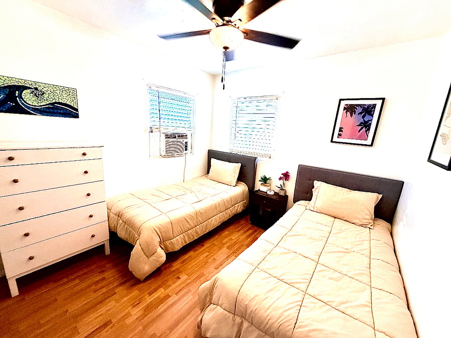 Spare bedroom with two new cozy beds and large 5 drawer dresser. 
