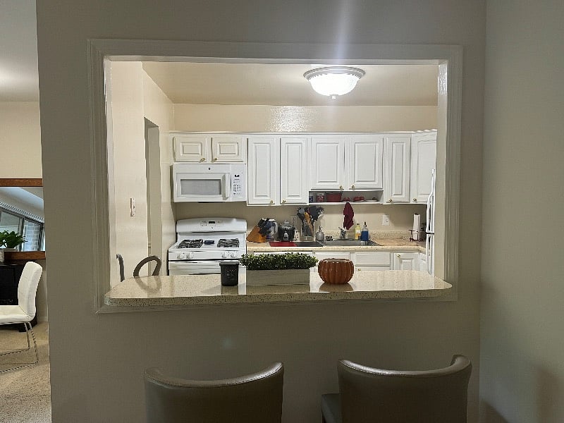 View of kitchen through the eat at bar