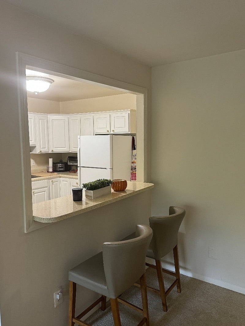 View of kitchen from relaxing living area
