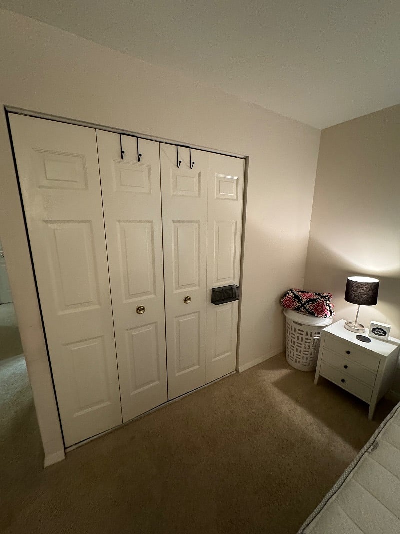 Double accordion doors with over the door hooks provided and a mail/inbox slot 