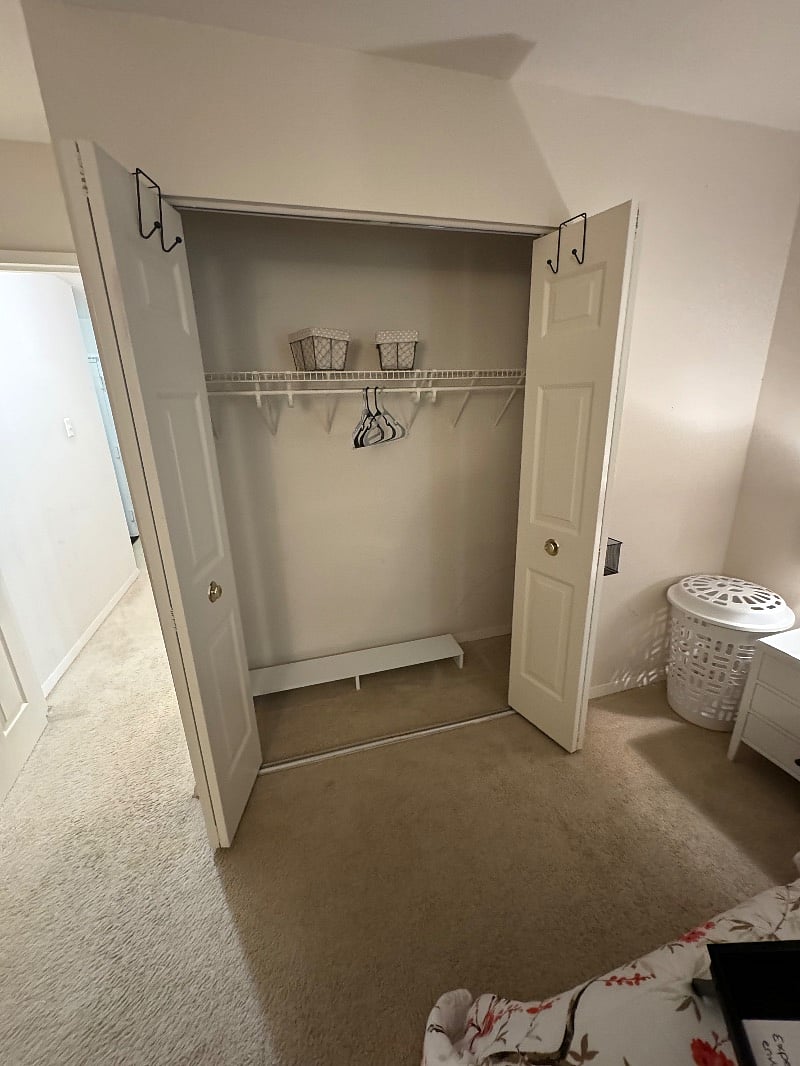 Bedroom closet with shoe rack and basket storage