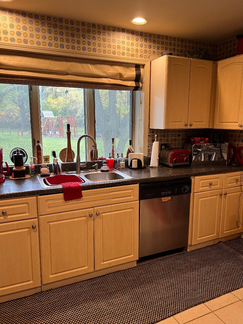 Well appointed kitchen with numerous small appliances, pots, dishes and utensils