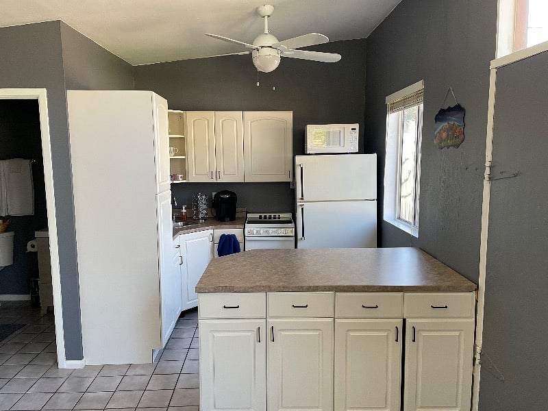 Kitchenette with full size refrigerator, newer glass top range, microwave, and Keurig. 