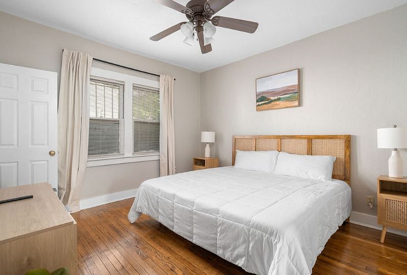 Master bedroom with plush king bed and blackout curtains