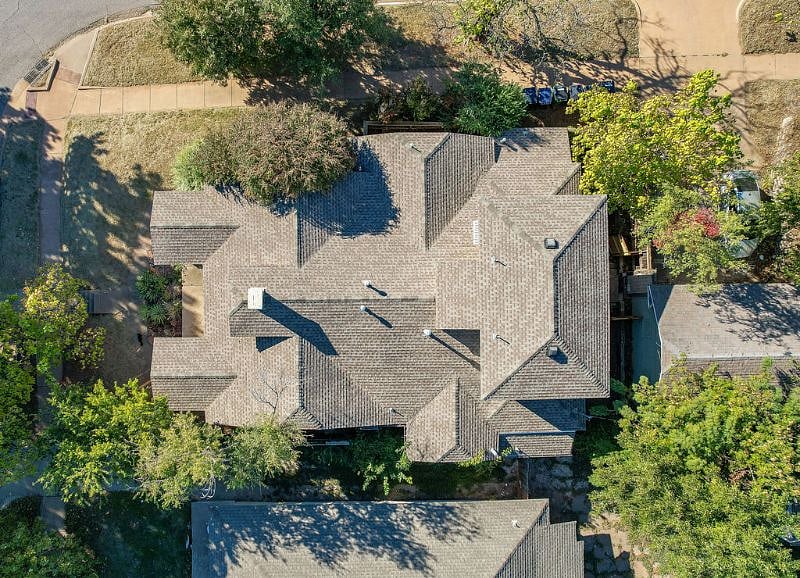 Property is surrounded by lush/mature landscaping