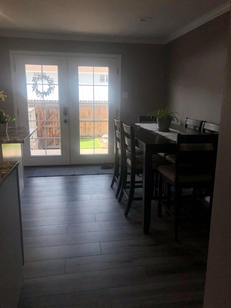 6 person dining table in kitchen. Back patio with seating available. Two covering parking spaces on other side of fence.