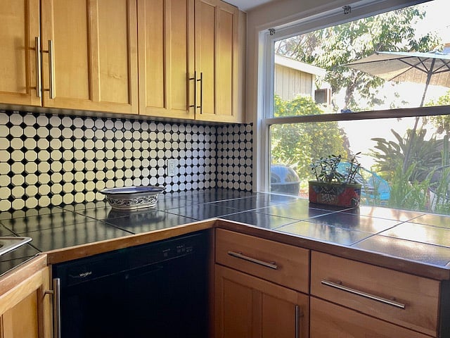 Luminous kitchen with direct view to the flowery backyard.