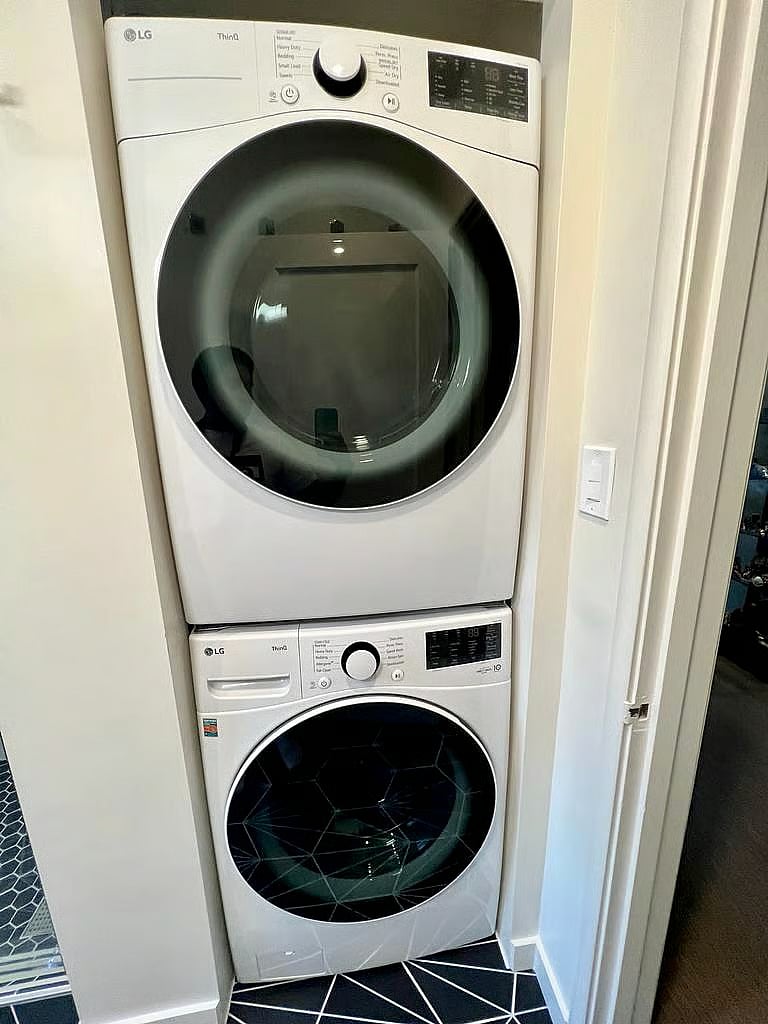 Full laundry area with full sized washer and dryer. 