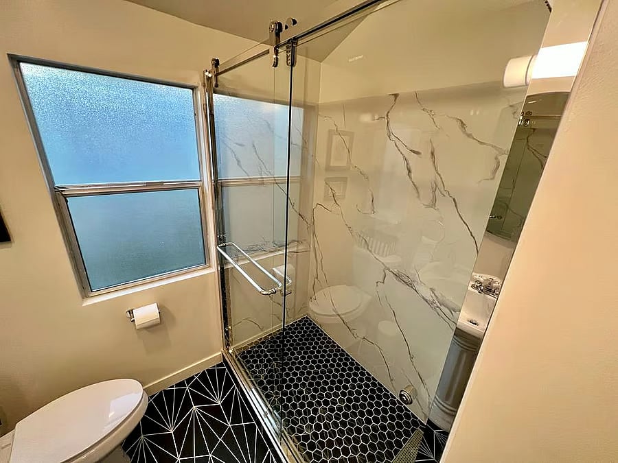 ample shower. sufficiently big for 2 bathers at once if needed. 