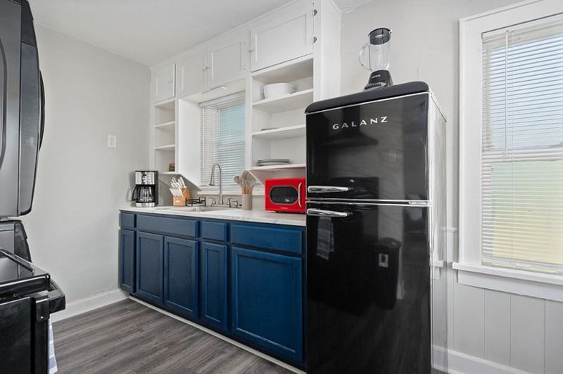 Kitchen with cabinet storage and open shelving for convenience