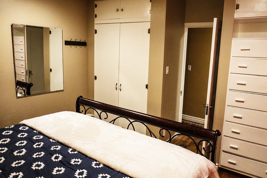 Primary bedroom with King bed and built in drawers and large closet