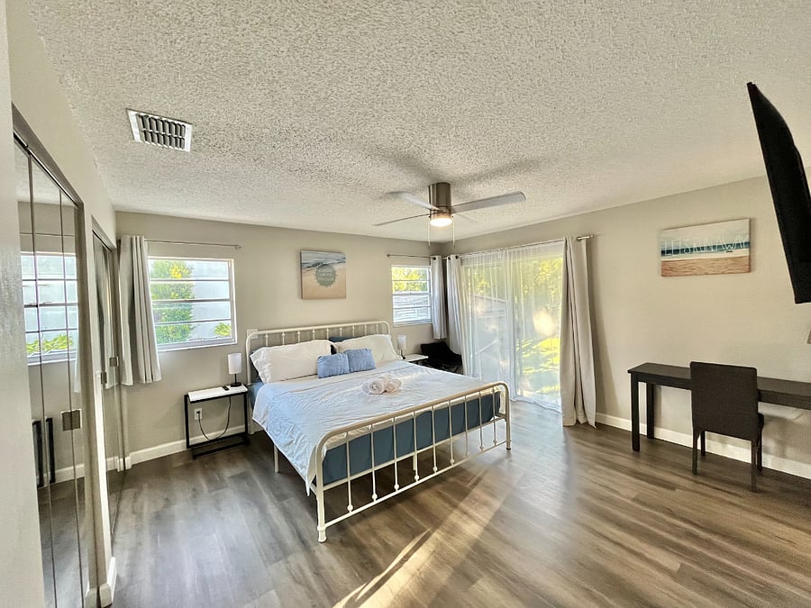 Large master bedroom with direct access to private bath and outdoor water front view