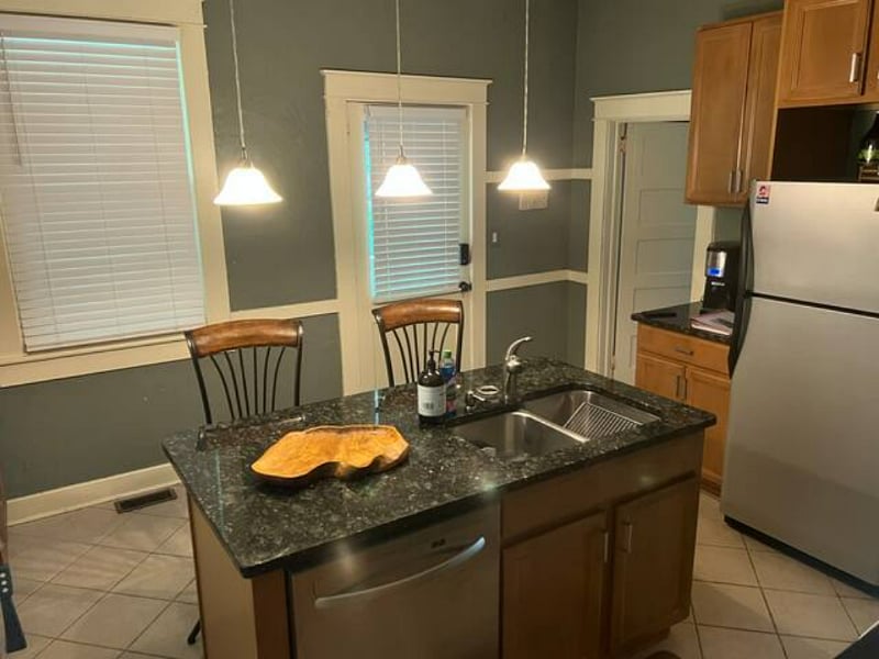 Kitchen space with the bathroom off to the right side of the kitchen.