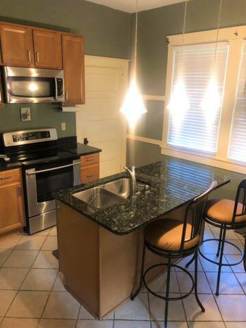 A beautifully lit kitchen adorned with granite countertops