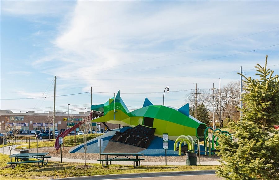 Nearby playground and shops.