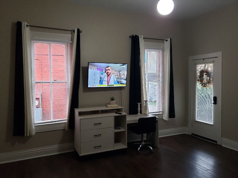 Smart TV on swivel mount & computer desk with drawers