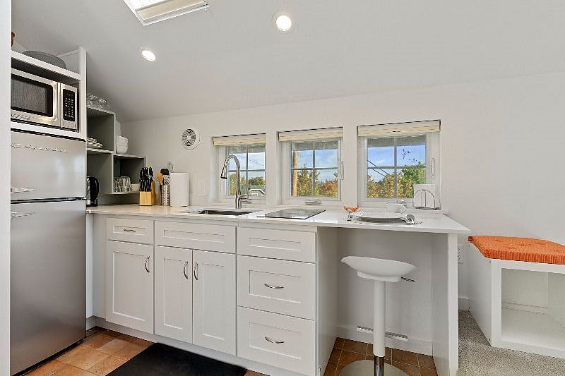 Newly remodeled kitchenette with induction cooktop , new cabinets, new refrigerator and microwave.