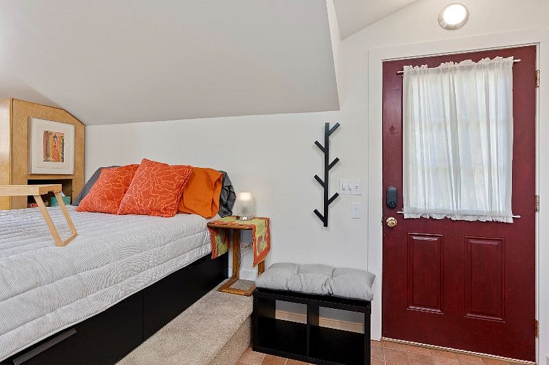 Double bed with storage drawers. Coat rack and shoe storage cubbies at entry.
