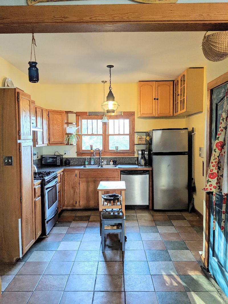 Upstairs kitchen with gas stove, microwave, toaster oven, coffee maker, and more.