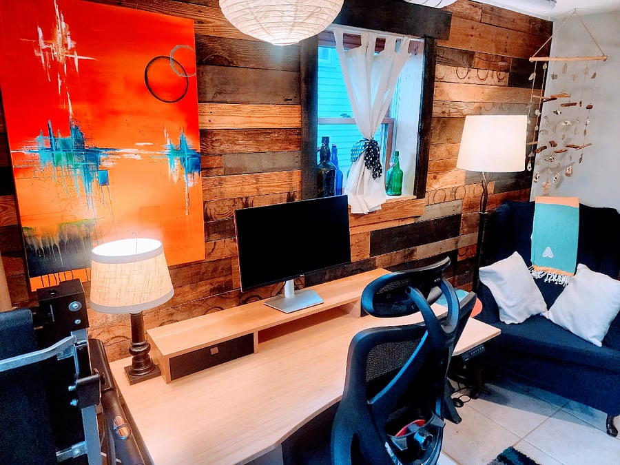 Downstairs workspace with sit/stand desk. There is another sit/stand desk work area upstairs. Upstairs desk is smaller.