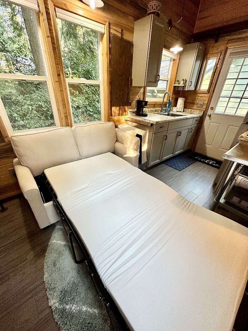 This is the couch when pulled out into its guest bed. Linens are included and stored in one of the cabinets.