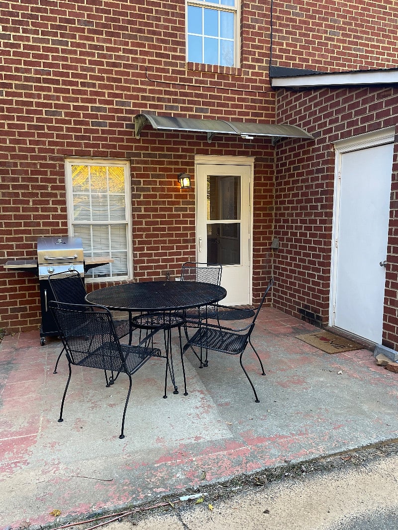 Back door, main entrance/ keyless entry door. Patio with BBQ.