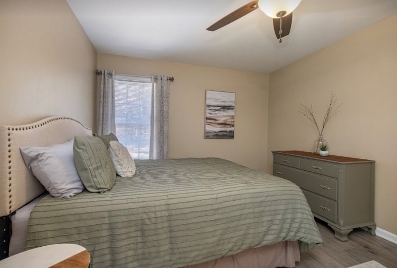 Queen bedroom with chest of drawers and closet.
