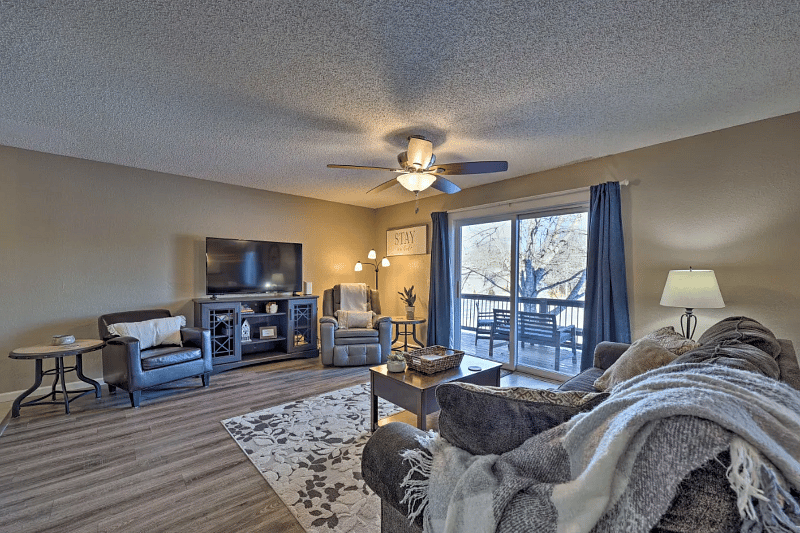 Living room area with smart TV, comfy electric recliner, deck access