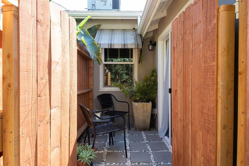 Private patio with two chairs and a table