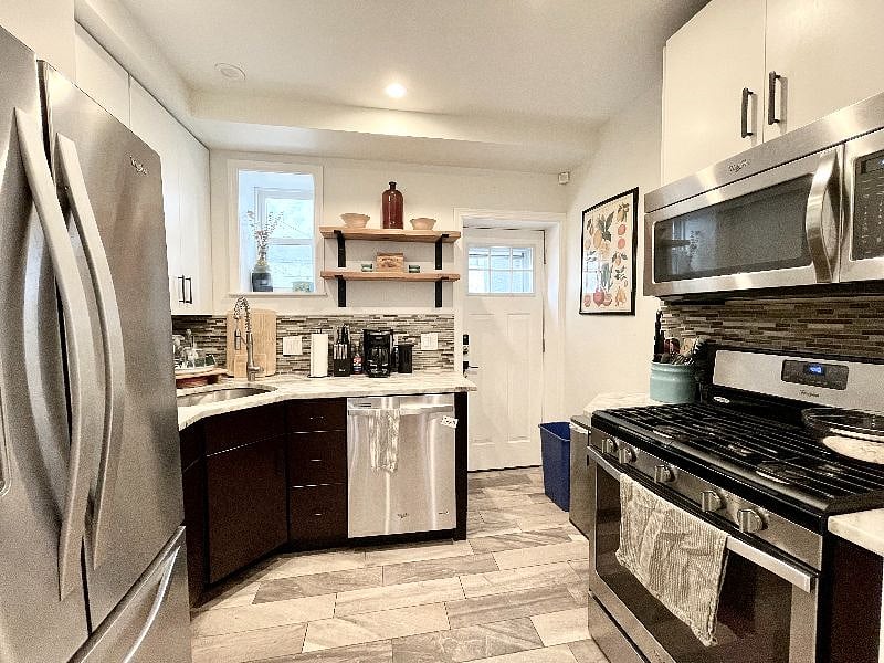 Kitchen with fridge, coffee maker, stove, oven, and microwave