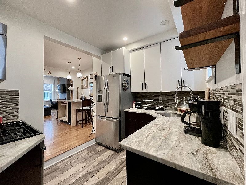 Kitchen with fridge, coffee maker, stove, oven, and microwave