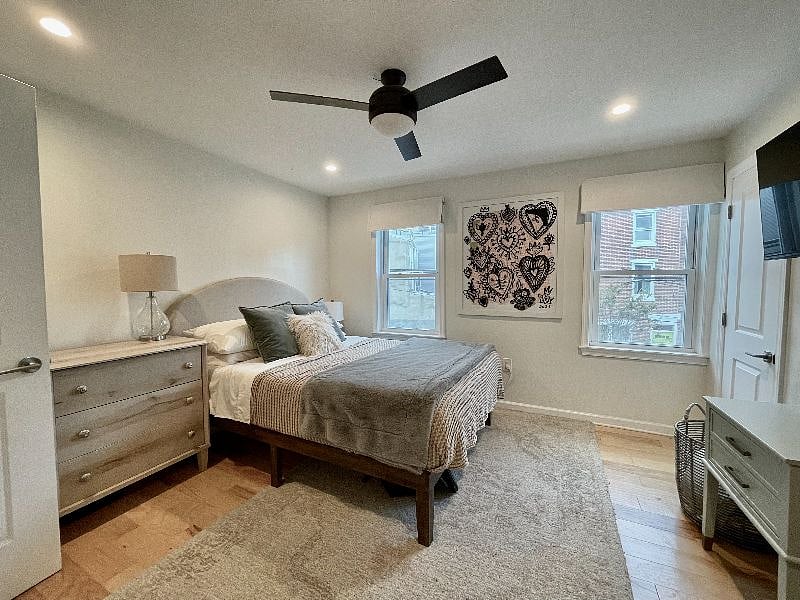 Main bedroom with dresser and bedside table