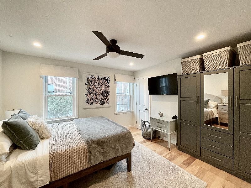 Main bedroom with armoire and mounted television